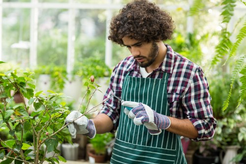 Gardeners working safely with tools in an outdoor setting
